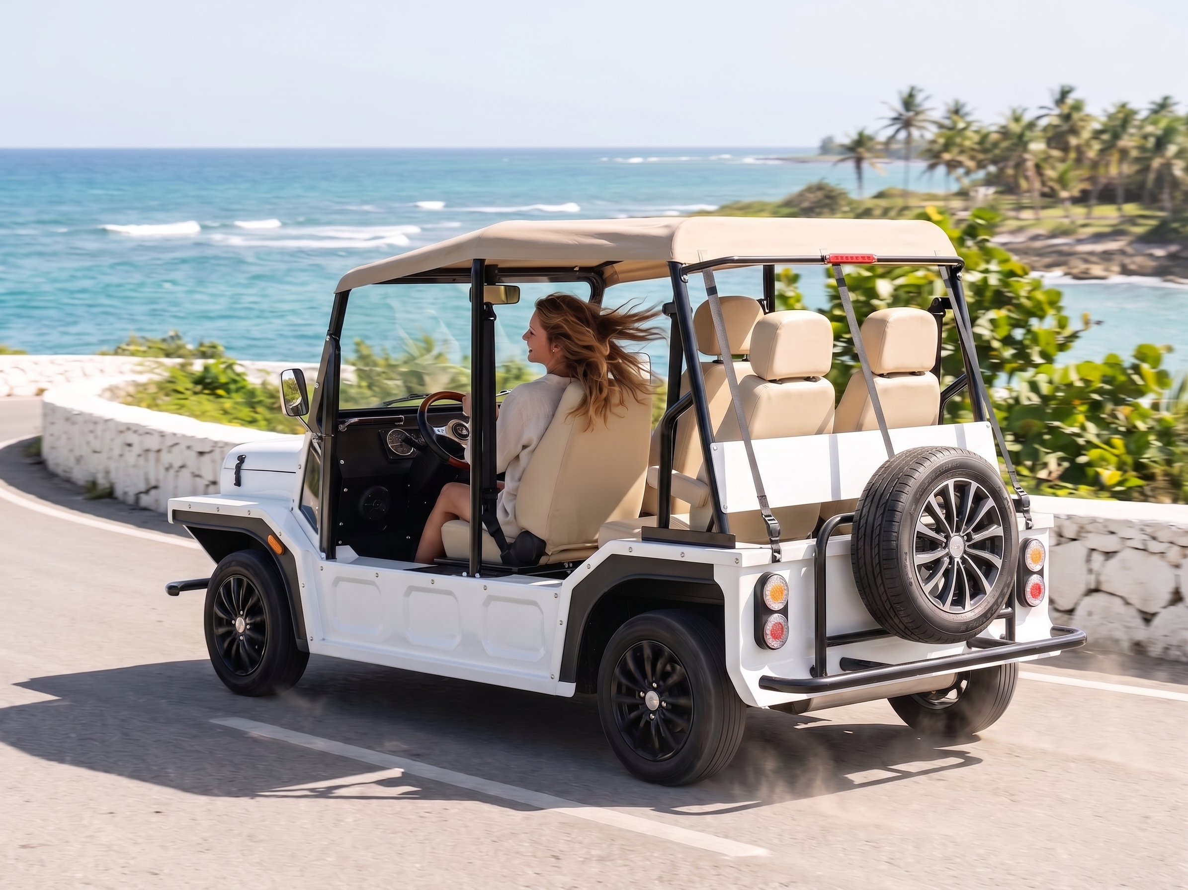 Person driving a white golf cart on a scenic road with ocean and palm trees in the background